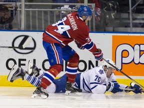 Toronto Maple Leafs forward Frederik Gauthier battles with Montreal Canadiens forward Michael McCarron for the puck during their NHL Rookie Tournament game at Budweiser Gardens in London, Ont. on Saturday September 12, 2015. (Craig Glover/The London Free Press/Postmedia Network)