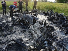 In this Aug. 23, 2015  photo made available by the firefighter brigade  in Wyszogrod, central Poland,  firefighters are retrieving the remains of a Soviet WW II fighter-bomber plane from muddy riverbed near Wyszogrod,. The Red Army plane was downed by the Germans in January 1945 and plunged into the  frosty river. Recent drought that brought river levels down has made access to the remains possible. (AP Photo/OSP Wyszogrod)