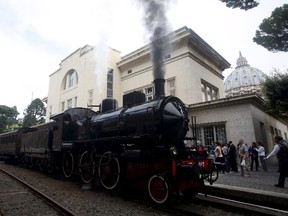 Smoke billows from a steam locomotive as it departs Vatican's train station, at the Vatican, September 11, 2015. REUTERS/Remo Casilli