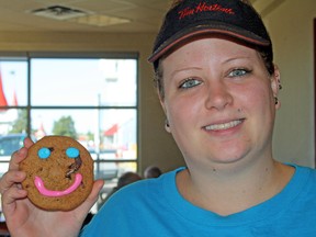 Sarah Hyatt/The Intelligencer
Kristen Gurdon, at the Bell Boulevard Tim Hortons location in Belleville, displays a Smile Cookie Monday. Tim Hortons' annual Smile Cookie Campaign is back and started on Monday. Proceeds from the Belleville locations help Big Brothers Big Sisters of Hastings and Prince Edward Counties.