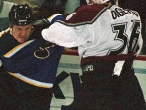 St. Louis Blues defenceman Rudy Poeschek (L) swings at Colorado Avalanche right wing Jeff Odgers during a fight in the first period in Denver January 16. (REUTERS)