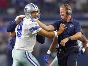Tony Romo of the Dallas Cowboys celebrates with coach Jason Garrett after throwing the game-winning touchdown against the New York Giants at AT&T Stadium on September 13, 2015 in Arlington, Tex. (Tom Pennington/Getty Images/AFP)