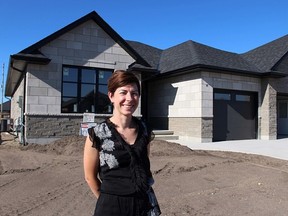 Kathy Alexander, with the Bluewater Health Foundation, stands in front of this year's Dream Home Lottery grand-prize home, still under construction on Manhattan Drive in Sarnia. Weekend open houses at the four-bedroom bungalow begin Oct. 17. (Tyler Kula, The Observer)