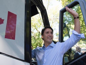 Liberal leader Justin Trudeau waves from his bus as he leaves a campaign stop in Fred Hamilton Park in Toronto, Monday, Sept. 14, 2015.  THE CANADIAN PRESS/Jonathan Hayward