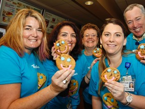It’s Smile Cookie time again, with representatives from Kingston-area Tim Hortons, the University Hospitals Kingston Foundation and Kingston General Hospital kicking off the week-long campaign at the 1166 Division St. Tim Hortons location on Monday. (Julia McKay/The Whig-Standard)