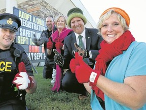 Luke Hendry/The Intelligencer
Partners in this year's Adopt-a-Child clothing program gather outside Belleville Police headquarters in Belleville Monday. From left are Prince Edward OPP Const. Anthony Mann, Stirling-Rawdon Police Const. Scott Burke, volunteer Barb Lea, TD-Canada Trust branch manager Nick O'Reilly, and program chairwoman Belleville Police Det. Const. Ann Earle-Dempsey.