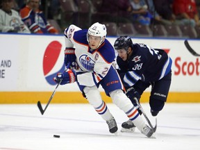 Edmonton's Leon Draisaitl goes around Winnipeg's Nic Petan Monday in Penticton (Perry Mah, Edmonton Sun).