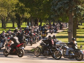 Hundreds of bikers follow a hearse to a gravesite in London?s Forest Lawn cemetery after the funeral of Steve Sinclair. A member of the Gate Keepers, a club associated with the Hells Angels, Sinclair was gunned down last week at a social club in London. (MIKE HENSEN, The London Free Press)