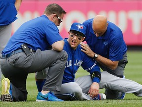 Blue Jays staff tend to shortstop Troy Tulowitzki after he collided with Toronto centre fielder Kevin Pillar fielding a fly ball in the second inning Saturday afternoon at Yankee Stadium. (Kathy Willens/AP)