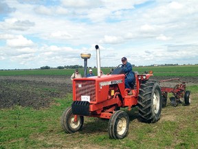 A vintage tractor makes its way around a field during O'Neil's Mini Farm Show held on Kim O'Neil's farm on Stewart Line on Saturday. The event featured a number of antique tractors and farm items. This was the 12th year for the Farm Show.