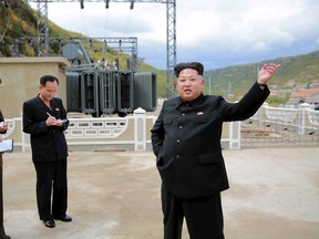 North Korean leader Kim Jong Un, right, gives field guidance during a visit to the construction site of the Paektusan Hero Youth Power Station near completion in this undated photo released by North Korea's Korean Central News Agency (KCNA) in Pyongyang, on Sept. 14, 2015. (REUTERS/KCNA)