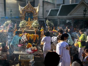 People pray after a religious ceremony at the Erawan shrine, the site of a recent deadly blast, after its was repaired, in central Bangkok, Thailand, September 4, 2015. REUTERS/Athit Perawongmetha