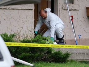 RCMP forensics work at the scene of a suspected homicide and child abduction in Blairmore, Alta., on Monday September 14, 2015. Mike Drew/Calgary Sun/Postmedia Network