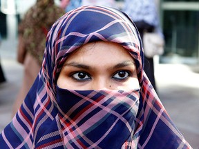 Zunera Ishaq talks to reporters outside the Federal Court of Appeal after her case was heard on whether she can wear a niqab while taking her citizenship oath, in Ottawa on Tuesday, Sept. 15, 2015. THE CANADIAN PRESS/ Patrick Doyle