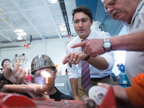 Liberal leader Justin Trudeau tours a pipe fitting training facility during a campaign stop in Waterloo, Ont., on Sept, 15, 2015. (THE CANADIAN PRESS/Jonathan Hayward)