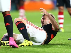 Manchester United’s Luke Shaw grimaces after being injured during the Champions League Group B match between PSV and Manchester United at Philips Stadium in Eindhoven, Netherlands, on Tuesday, Sept. 15, 2015. (Peter Dejong/AP Photoa)