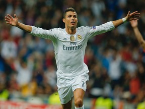 Real Madrid's Cristiano Ronaldo celebrates after scoring a hat trick during a Group A Champions League soccer match between Real Madrid and Shakhtar Donetsk at the Santiago Bernabeu stadium in Madrid on Sept. 15, 2015. (AP Photo/Paul White)