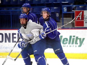 Sudbury Wolves hopeful Macauley Carson fights for position with Trenton Bourque during  team practice at the Sudbury Community Arena in Sudbury, Ont. on Tuesday September 15, 2015.