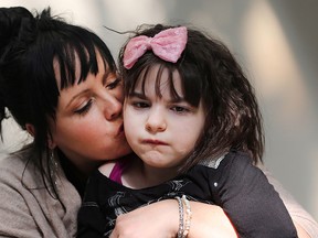 Sarah Wilkinson and her nine-year old daughter Mia at Canadian Cannabis Clinics in St. Catharines on Monday, Sept. 14, 2015. THE CANADIAN PRESS/Peter Power