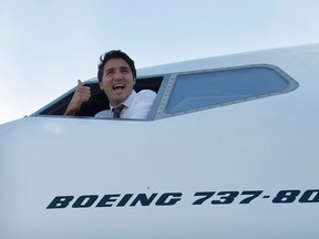 Liberal Leader Justin Trudeau gives the thumbs up from the pilot's window of his campaign plane in Mississauga, Ont., prior to flying to Calgary, Tuesday, Sept, 15, 2015. THE CANADIAN PRESS/Jonathan Hayward