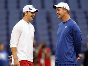 New York Giants quarterback Eli Manning talks with his brother Indianapolis Colts quarterback Peyton Manning before the start of their NFL football game in Indianapolis on Sept. 19, 2010. (REUTERS/Brent Smith)