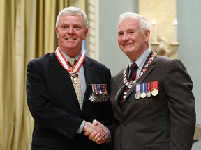 Retired General Rick Hillier (L) shakes hands with Governor General David Johnston after being awarded the rank of Officer in the Order of Canada at Rideau Hall in Ottawa September 28, 2012. REUTERS/Chris Wattie