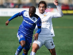 Sainey Nyassi, shown here battling Fort Lauderdale defender Daniel Navarro for the ball during a match in April, recently returned from a stint with the Gambian national team. (Ian Kucerak, Edmonton Sun)