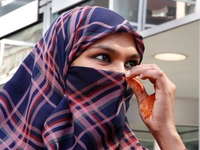 Zunera Ishaq talks to reporters outside the Federal Court of Appeal after her case was heard on whether she can wear a niqab while taking her citizenship oath, in Ottawa on Tuesday, September 15, 2015. (THE CANADIAN PRESS/Patrick Doyle)