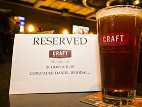 A glass of beer is set aside in honour of Cst. Daniel Woodall during the launch event at CRAFT Beer Market of Two Sergeants Patrolman ESB (English style bitter) in Edmonton, Alta. on Tuesday, Sept. 15, 2015. (CODIE MCLACHLAN/Edmonton Sun)