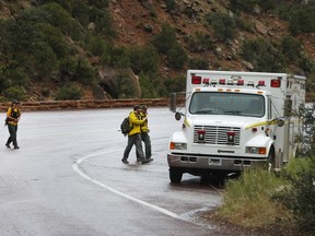 Search and rescue personal finish their day of searching Pine Creek in Zion's National Park for lost hikers on September 15, 2015 in Springdale, Utah. Four hikers died and three are missing after a flash flood yesterday that also killed several woman and children in two vans that were swept away by the flood waters.  George Frey/Getty Images/AFP