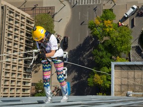Mary Holmes, 89, rappels down One London Place as part of the Easter Seals Drop Zone, a fundraiser that has raised about $490,000 in four years in London. The event is held at One London Place on Wednesday. Mike Hensen/The London Free Press/Postmedia Network