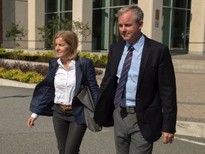 Dennis Oland and his wife Lisa head from his trial in Saint John, N.B. on Wednesday, Sept. 16, 2015. Oland is charged with second degree murder in the death of his father. Richard Oland, 69, was found dead in his Saint John office on July 7, 2011. THE CANADIAN PRESS/Andrew Vaughan