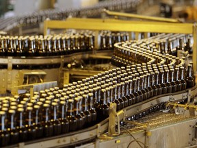 Bottles of beer move along a production line at South African Breweries, owned by SABMiller, in Alrode, South Africa in this April 2, 2009 file photo. REUTERS/Siphiwe Sibeko/Files