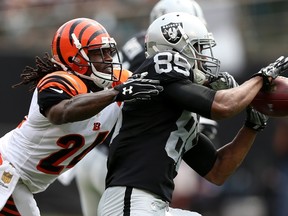 Bengals cornerback Adam Jones (left) defends a pass to Raiders reciever Amari Cooper (right) during NFL action in Oakland, Calif., on Sunday, Sept. 13, 2015. (Ezra Shaw/Getty Images/AFP)