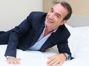 Jean Dujardin, star of the film Un Plus Une, jokingly naps and rests on a bed while taking photographs during the Toronto International Film Festival in Toronto on Friday September 11, 2015. Veronica Henri/Toronto Sun/Postmedia Network