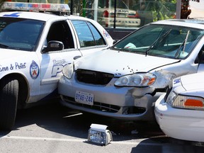 Bullet holes can be seen in an alleged stolen car as Toronto Police investigate the scene at Parlaiment and Mill St after a daytime shooting on Wednesday September 16, 2015. Dave Abel/Toronto Sun/Postmedia Network