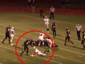 A screen grab shows a New Jersey high school football player appearing to bash another player's head with his own helmet.