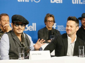 'Black Mass' star Johnny Depp, left, and director Scott Cooper attend the press conference for the film at the TIFF Bell Lightbox at the Toronto International Film Festival in Toronto on Monday September 14, 2015. Stan Behal/Toronto Sun/Postmedia Network