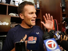 New England Patriots quarterback Tom Brady speaks with members of the media in the locker room before an NFL football practice, Wednesday, Sept. 16, 2015, at Gillette Stadium, in Foxborough, Mass. (AP Photo/Steven Senne)