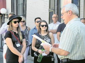 Sarah Hyatt/The Intelligencer
Councillor Jack Miller leads a group on a walking tour of downtown Belleville, as part of the Explore the Core event. Here he talks about the success of Bourbon Street Pizza outside the restaurant Wednesday,