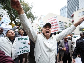 Cab drivers protest as dual rallies of Uber and cab drivers clash outside  City Hall in Edmonton on Wednesday September 16, 2015. (IAN KUCERAK/Edmonton Sun)