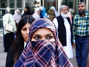 Zunera Ishaq talks to reporters outside the Federal Court of Appeal after her case was heard on whether she can wear a niqab while taking her citizenship oath, in Ottawa on Tuesday, September 15, 2015. THE CANADIAN PRESS/ Patrick Doyle