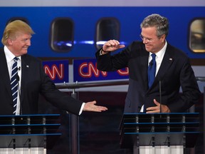 Republican presidential candidate, businessman Donald Trump, left, and Jeb Bush slap hands near the finish of the CNN Republican presidential debate at the Ronald Reagan Presidential Library and Museum on Wednesday, Sept. 16, 2015, in Simi Valley, Calif. (AP Photo/Mark J. Terrill)