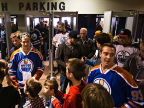 Fans enter the building through Rexall Place's new security gates during the Edmonton Oilers rookies' exhibition hockey game against the University of Alberta Golden Bears at Rexall Place in Edmonton, Alta. on Wednesday, Sept. 16, 2015. Codie McLachlan/Edmonton Sun/Postmedia Network