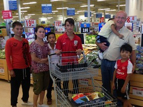 Casey Willemse, right, goes grocery shopping with the family of Myanmar refugees he and four local churches sponsored. The church communities raised about $20,000 to support a family of six as they build their life in Canada. The family arrived in St. Thomas at the end of July.