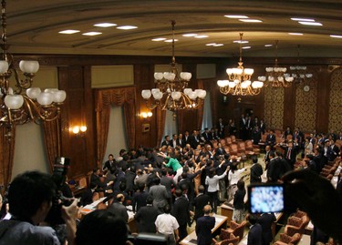 Ruling and opposition lawmakers scuffle as the voting for security bills are being held at an upper house committee in Tokyo Thursday, Sept. 17, 2015. Japan�s ruling Liberal Democratic Party pushed contentious security bills through a legislative committee, catching the opposition by surprise and causing chaos in the chamber. If the vote stands, the legislation will go to the upper house of parliament for final approval. (AP Photo/Shuji Kajiyama)