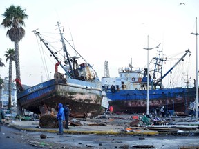 People look at ships in the street after an earthquake hit areas of central Chile, in Coquimbo city, north of Santiago, Chile, on Sept. 17, 2015. (REUTERS/Mauricio Ubilla)