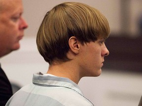 Dylann Roof (R), the 21-year-old man charged with murdering nine worshippers at a historic black church in Charleston last month, listens to proceedings with assistant defense attorney William Maguire during a hearing in Charleston, S.C>, in this file photo taken July 16, 2015.   REUTERS/Randall Hill/Files