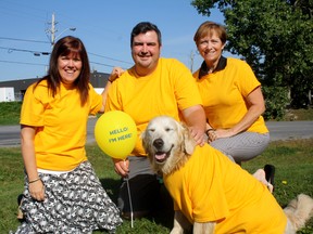 Hastings-Prince Edward County and Brighton Canadian Cancer Society, volunteer engagement co-ordinator, Tracey Reid, (left), Brad Walker, community fundraising specialist and event co-ordinator, and Ann Cooper, transportation co-ordinator for the society, with Lucy, sport gold outside the society's office, in Belleville Wednesday.