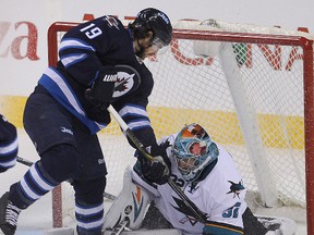 Jim Slater (left) has a shot blocked by San Jose Sharks goalie Alex Stalock during a game last March. (Brian Donogh/Winnipeg Sun file photo)